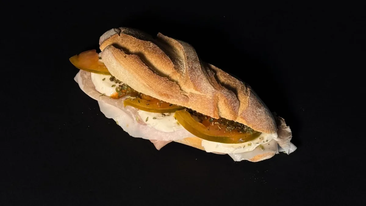Panino con prosciutto, mozzarella e pomodoro